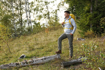 Poster - Man with yellow backpack outdoors, space for text. Tourism equipment