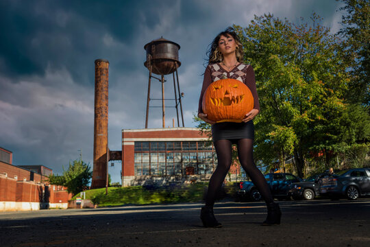 Model Poses With A Jack O Lantern For The Halloween holiday in the United States