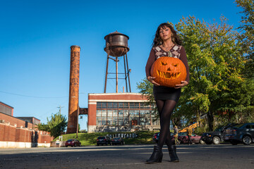 Wall Mural - Model Poses With A Jack O Lantern For The Halloween holiday in the United States