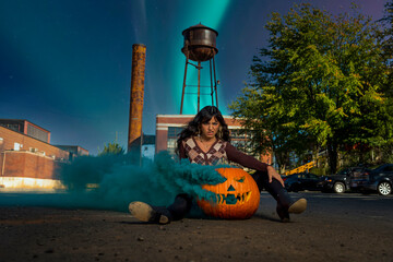 Wall Mural - Model Poses With A Jack O Lantern With Smoke For The Halloween holiday in the United States