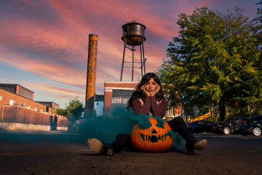 Model Poses With A Jack O Lantern With Smoke For The Halloween holiday in the United States