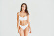 © GVS - Young and sporty woman in underwear posing on white studio background  with copy space