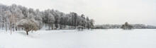 Winter View Of A Snow-covered Pond And Trees Around