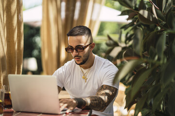 Poster - Beautiful horizontal shot of a guy working on his computer outdoors