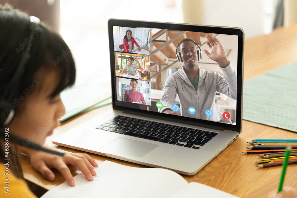Asian girl using laptop for video call, with diverse elementary school ...