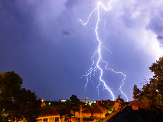 Wall Mural - image of an admirable thunder lightning in a small village.