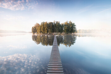 Poster - Old wooden bridge in park. Beautiful colored trees with lake in autumn, landscape photography. Summer and Late autumn. Outdoor and nature.
Amazing foggy morning. Lake coast. Fog over autumn lake water