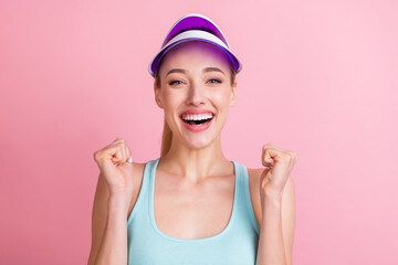 Wall Mural - Photo of hooray blond young lady hands fists yell wear blue top visor isolated on pink color background