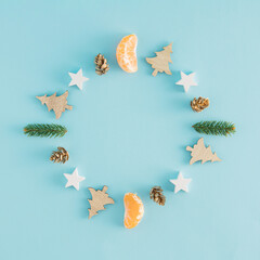 Wall Mural - A creative arrangement made of Christmas things in the shape of a circle on a pastel blue background. Minimal New Year concept with copy space. Christmas time inspiration.