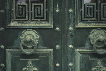 Wall Mural - Green vintage old metal doors with door knocker.
