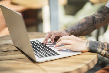 Sticker - Closeup of a guy's hands typing on a laptop keyboard