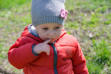 Little girl crying on the street walking in the park.