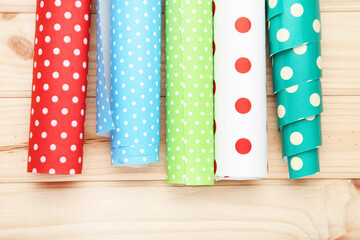 Canvas Print - Rolls of craft papers on wooden background