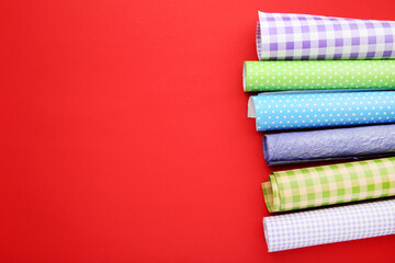 Canvas Print - Rolls of craft papers on red background