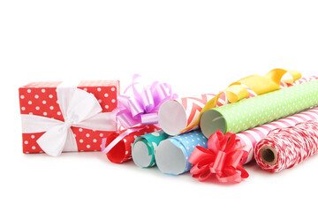 Wall Mural - Rolls of craft papers with ribbon bows and gift box on white background