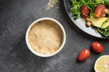 Gluten Free Nutritional Yeast Flakes In Ceramic Bowl. Ingredient For Vegan Food. Closeup, Copy Space