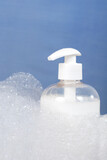 Fototapeta Mapy - Close up photo of hand soap bottle  and bubbles. Hygiene and personal care concept.