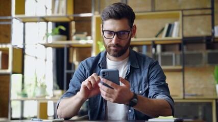 Smart caucasian business man using mobile phone for chatting typing message