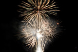Fototapeta Dmuchawce - Fireworks display isolated on black with copy space. Pyrotechnic background for greeting card or festival celebration poster. Vertical format
