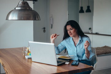 Young beautiful businesswoman in her office using a laptop