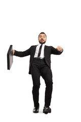 Wall Mural - Full length portrait of a shocked businessman with a briefcase falling on a slippery ground