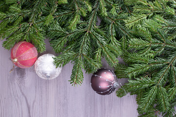 Fir tree branches on grunge wooden background.