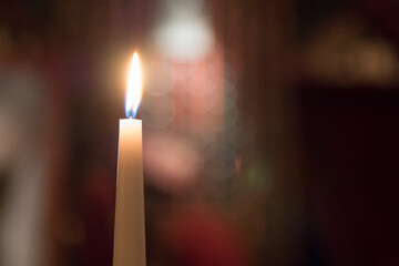 Wall Mural - Flame of a candle with a blurred winery background