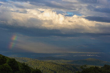  Bright rainbow column over the mountains and forest. Panoramic view from Mon Jam Hill ,Chiang Mai in Thailand