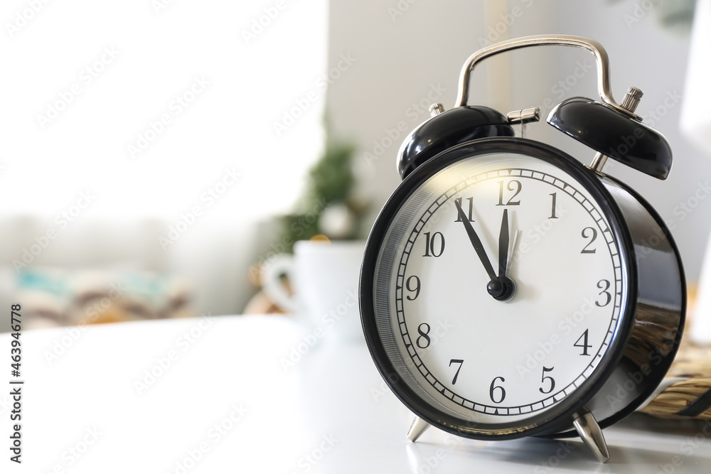 Vintage alarm clock on table in room, closeup