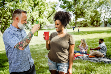 Wall Mural - Friends having a picnic in the park