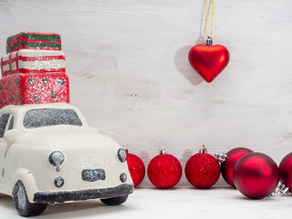 Wall Mural - Set of Christmas ornaments and a white toy car on a wooden background