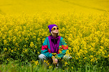 Stylish Girl In 90s Tracksuit In Rapeseed Field
