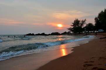 View landscape seascape of Chao Lao sand beach and wave water in sea ocean at sunset dusk time for thai people and foreign travelers travel visit and rest relax play swimming at Chanthaburi, Thailand