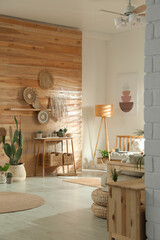 Wall Mural - Stylish living room interior with wooden furniture and beautiful houseplants