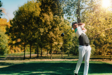 Wall Mural - Young golfer hitting the ball