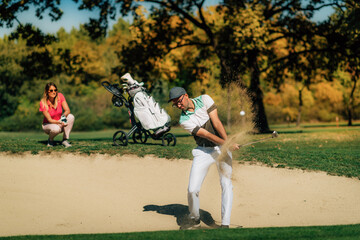 Wall Mural - Golfer playing from the sand trap