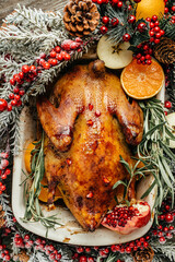 Wall Mural - Baked whole duck with fresh rosemary and oranges, Roasted duck. Dish for Christmas Eve, top view