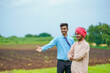 © PRASANNAPIX - Indian farmer Discussing with agronomist at agriculture field and collecting some information