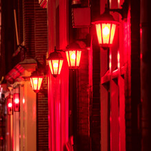 Background - Red Light District In Amsterdam At Night.  Selective Focus On One Lamp And Defocus The Rest. Amsterdam, Holland, Europe