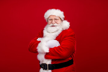 Sticker - Photo of handsome confident man pensioner dressed santa claus costume taarms folded smiling isolated red color background