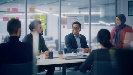 Wall Mural - Multi-Ethnic Office Conference Room. Brilliant Muslim Female CEO Wearing Hijab does Presentation for Group of Managers Talking, Using TV Infographics, Statistics. Innovative Businesspeople. Medium Pan