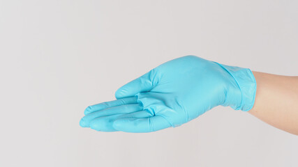 Wall Mural - Empty hand palm wearing medical glove isolated on white background.