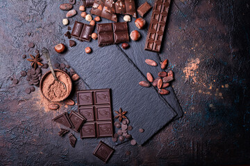 Wall Mural - Chocolate background with slate board and lots of bars, nuts, cocoa beans