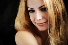 Woman With Smokey Eyes And Honey Blond Hair Smiling