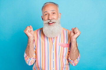 Sticker - Photo of aged man happy positive smile rejoice victory success fists hands isolated over blue color background