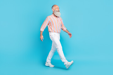 Sticker - Full length profile side photo of aged man happy positive smile go walk look empty space isolated over blue color background