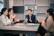 © sticker2you - Business people meeting and discussing documents and ideas at meeting around table.