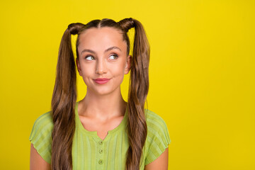 Wall Mural - Portrait of attractive bewildered cheerful brown-haired girl overthinking copy space isolated over bright yellow color background