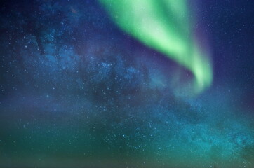 starry night blue green  sky nebula  on pink sunset Aurora borealis milky way dramatic clouds cosmic space weather forecast blue green light constellation background 