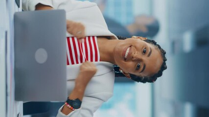 Poster - Vertical Screen: Young Successful Black Project Manager Dances and Smiles While Sitting at Her Desk. Beautiful Female Specialist Works Creative Office, Celebrates Successful e-Commerce Project